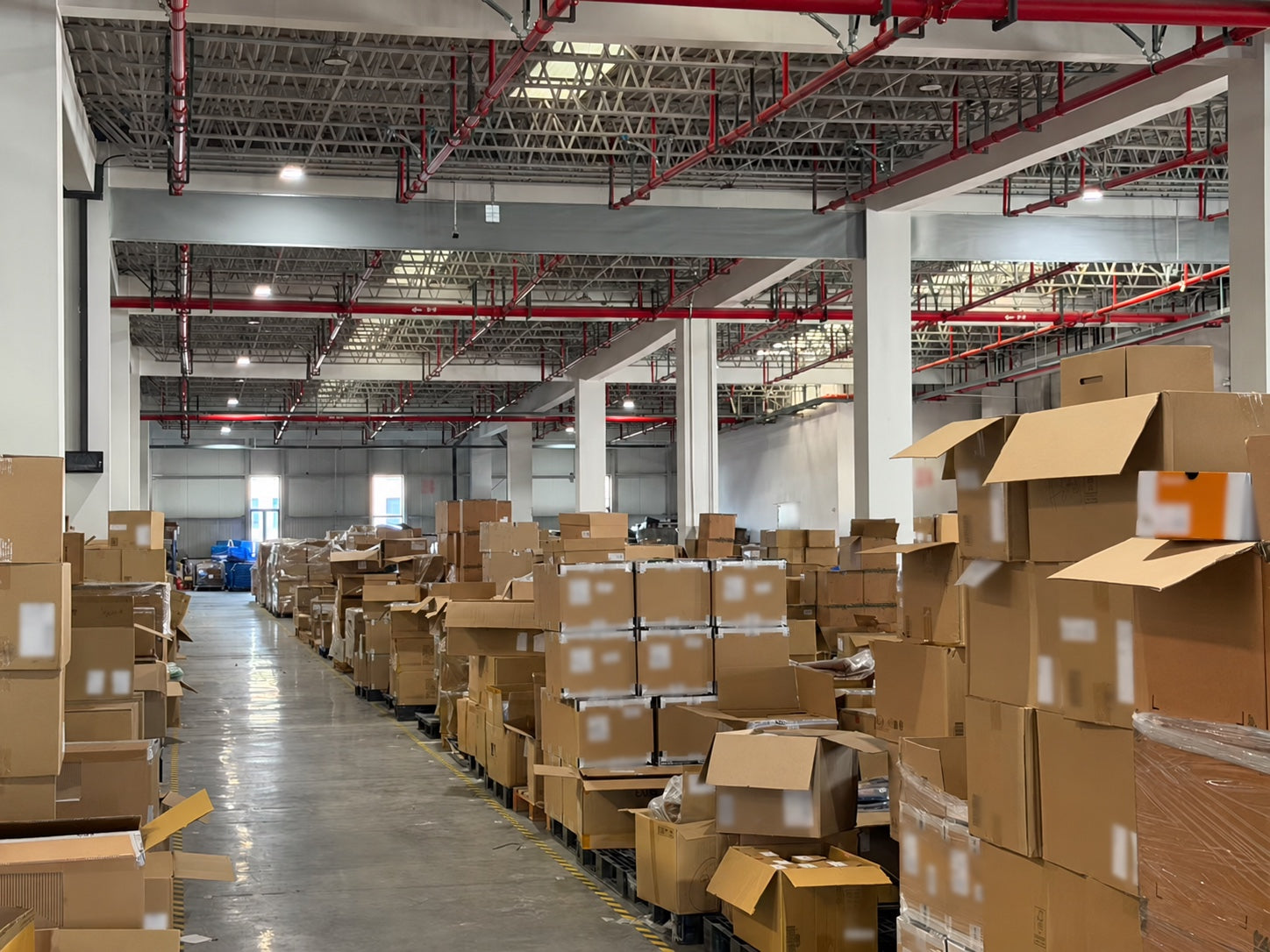 A China warehouse aisle filled with cartons prepared for footwear and apparel trade