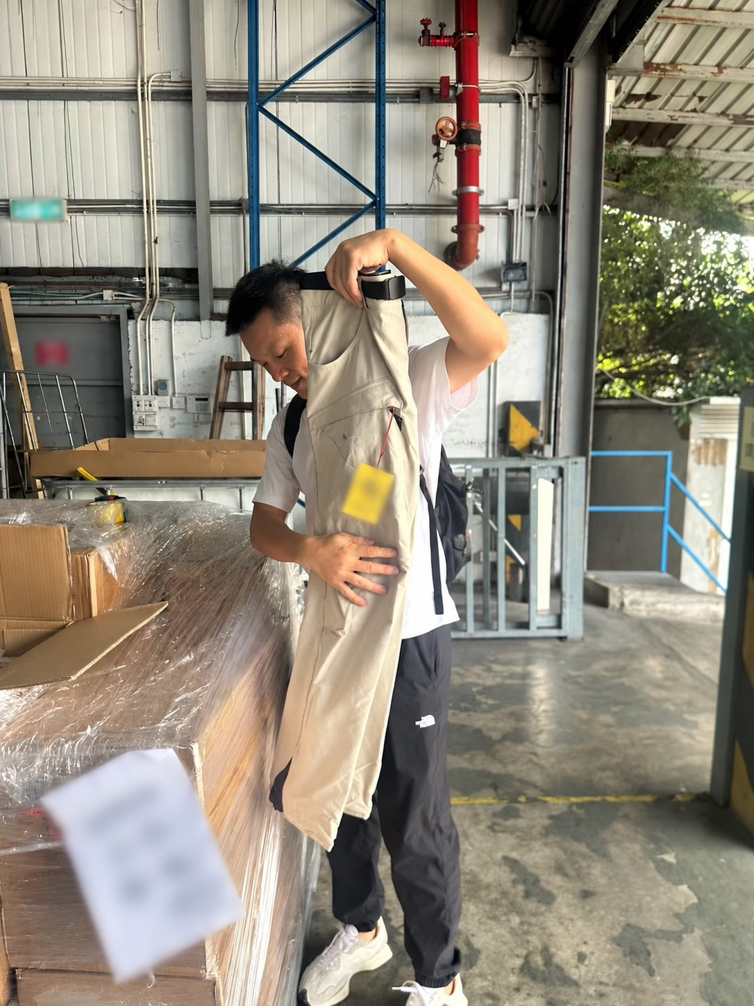 Joseph inspecting a pair of trousers during apparel sourcing work