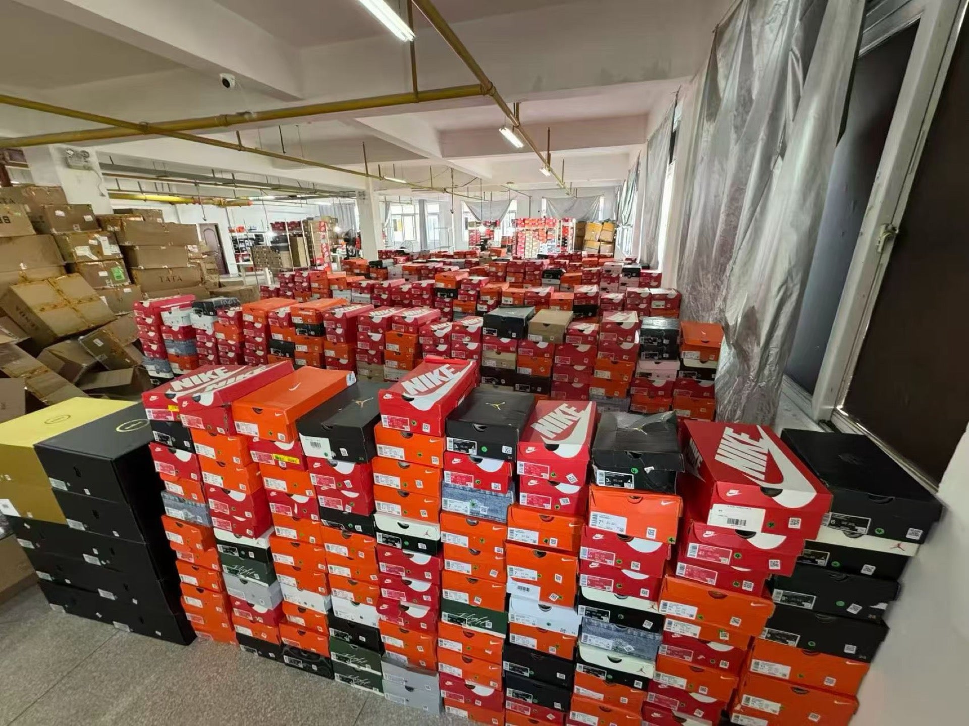 Nike footwear inventory organized across a warehouse floor in China