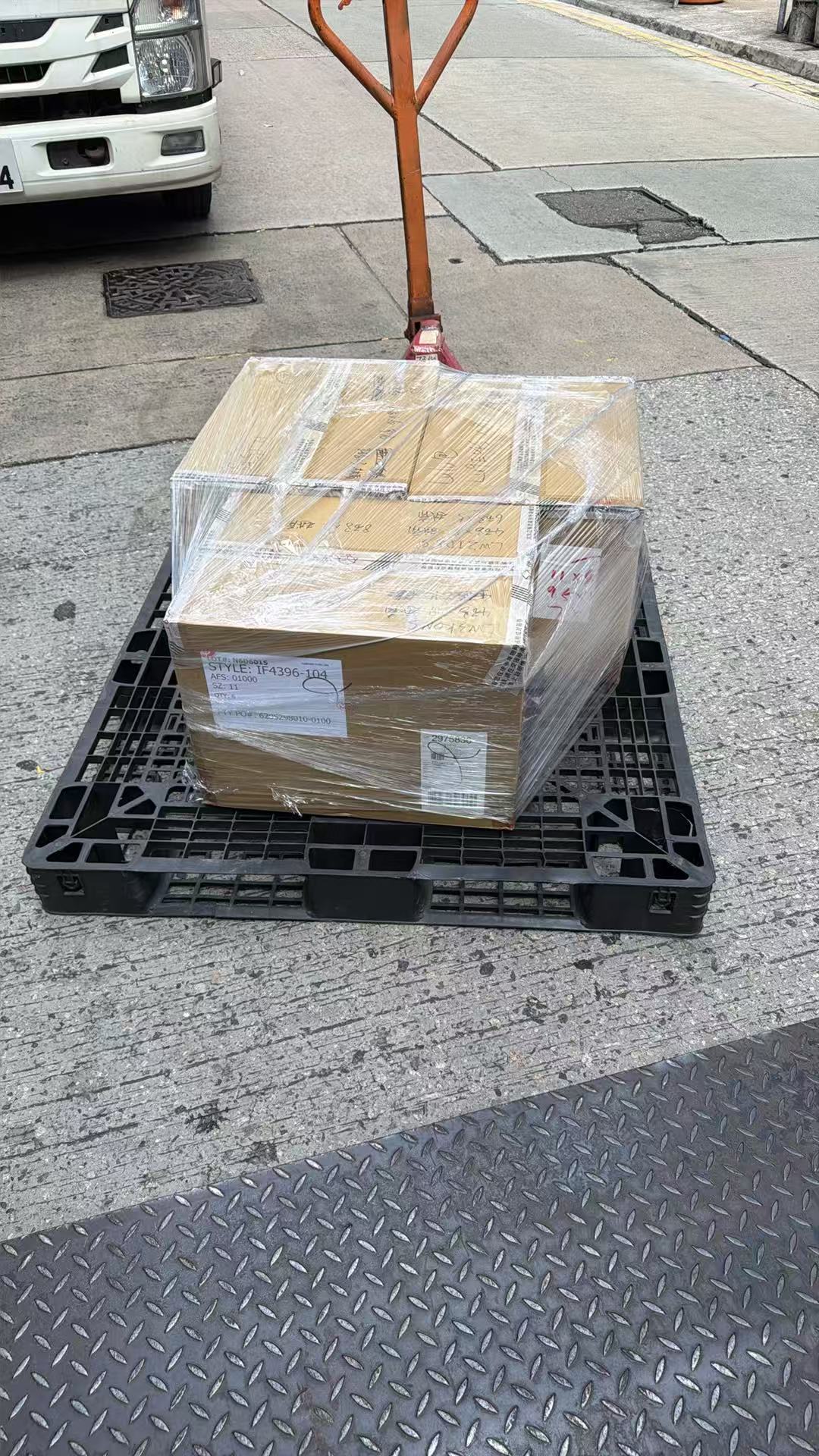Wrapped footwear cartons moved on a pallet for outbound delivery